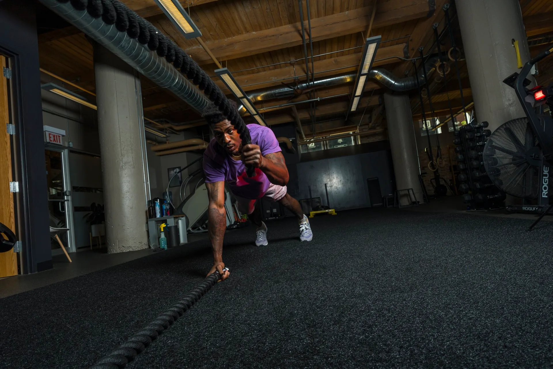 Jamal demonstrating a floor-based strength exercise in the gym